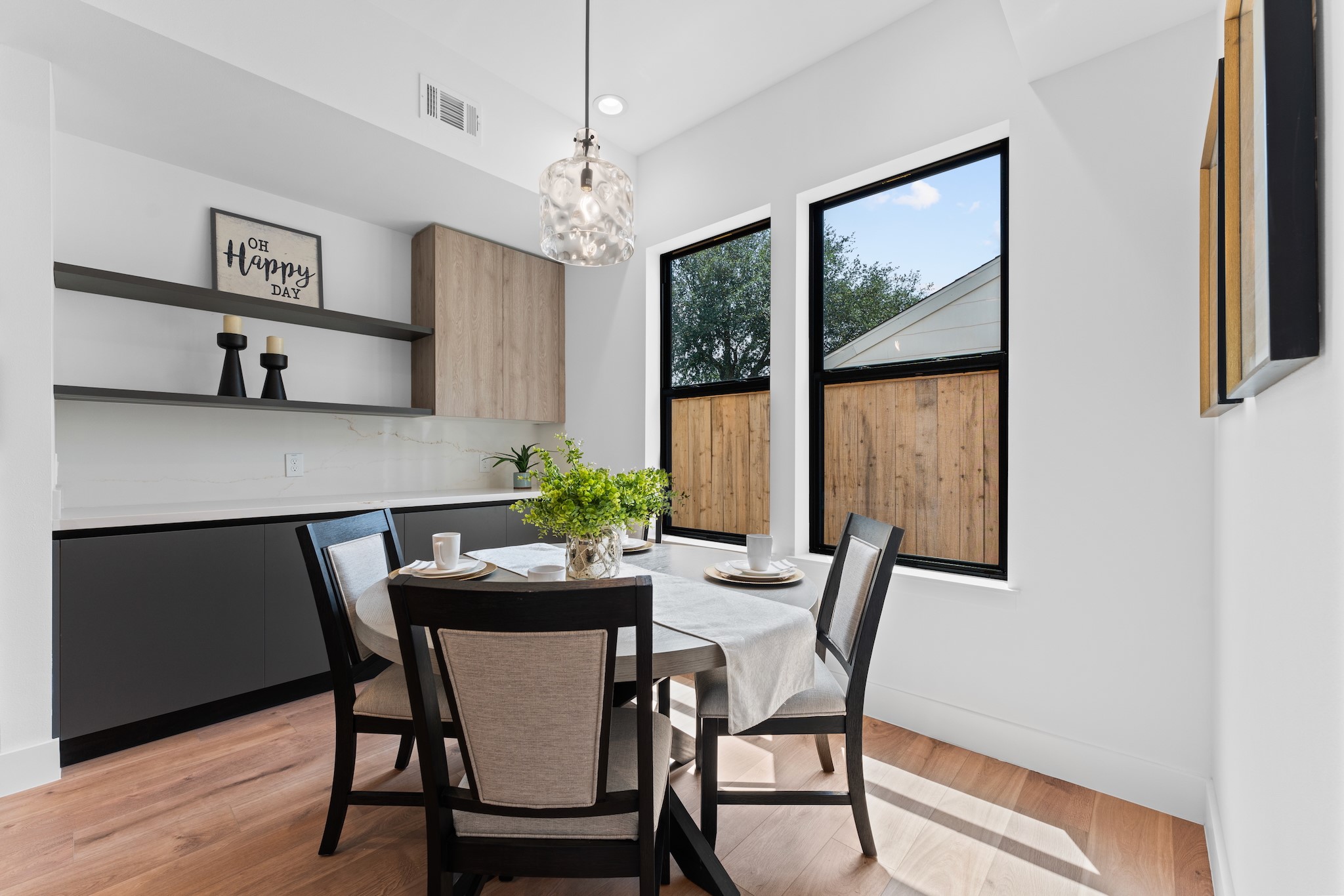 6711 Housman Houston, TX 77055 - Photo 13 of 49 Flooded with light, this casual breakfast nook tucks effortlessly into the kitchen’s architectural rhythm and tucks away even more kitchen storage.