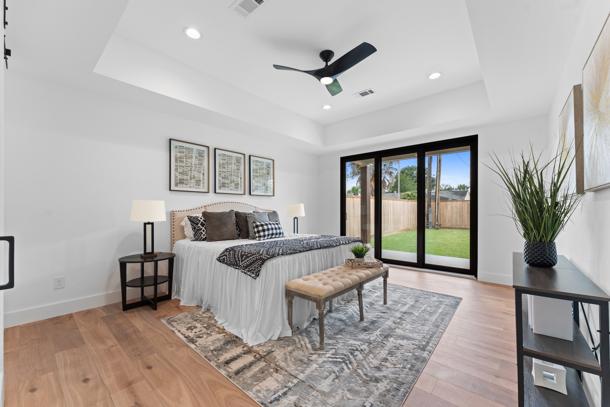 6711 Housman Houston, TX 77055 - Photo 20 of 49 A true owner’s retreat, anchored by a tray ceiling, recessed lighting, and peaceful backyard access.