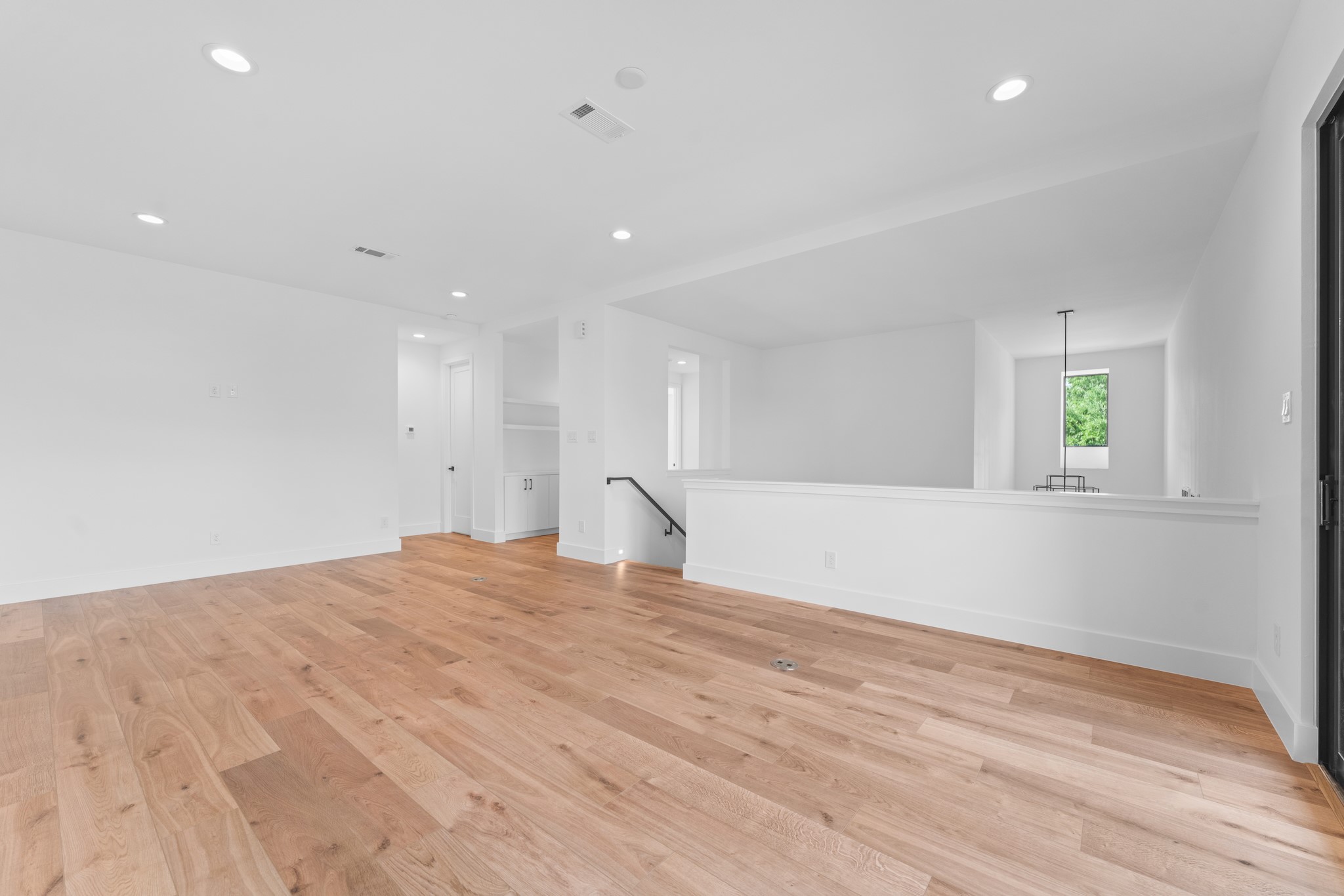 6711 Housman Houston, TX 77055 - Photo 37 of 49 Wide open and inviting — a space designed to grow with your life, from movie nights to craft sessions.