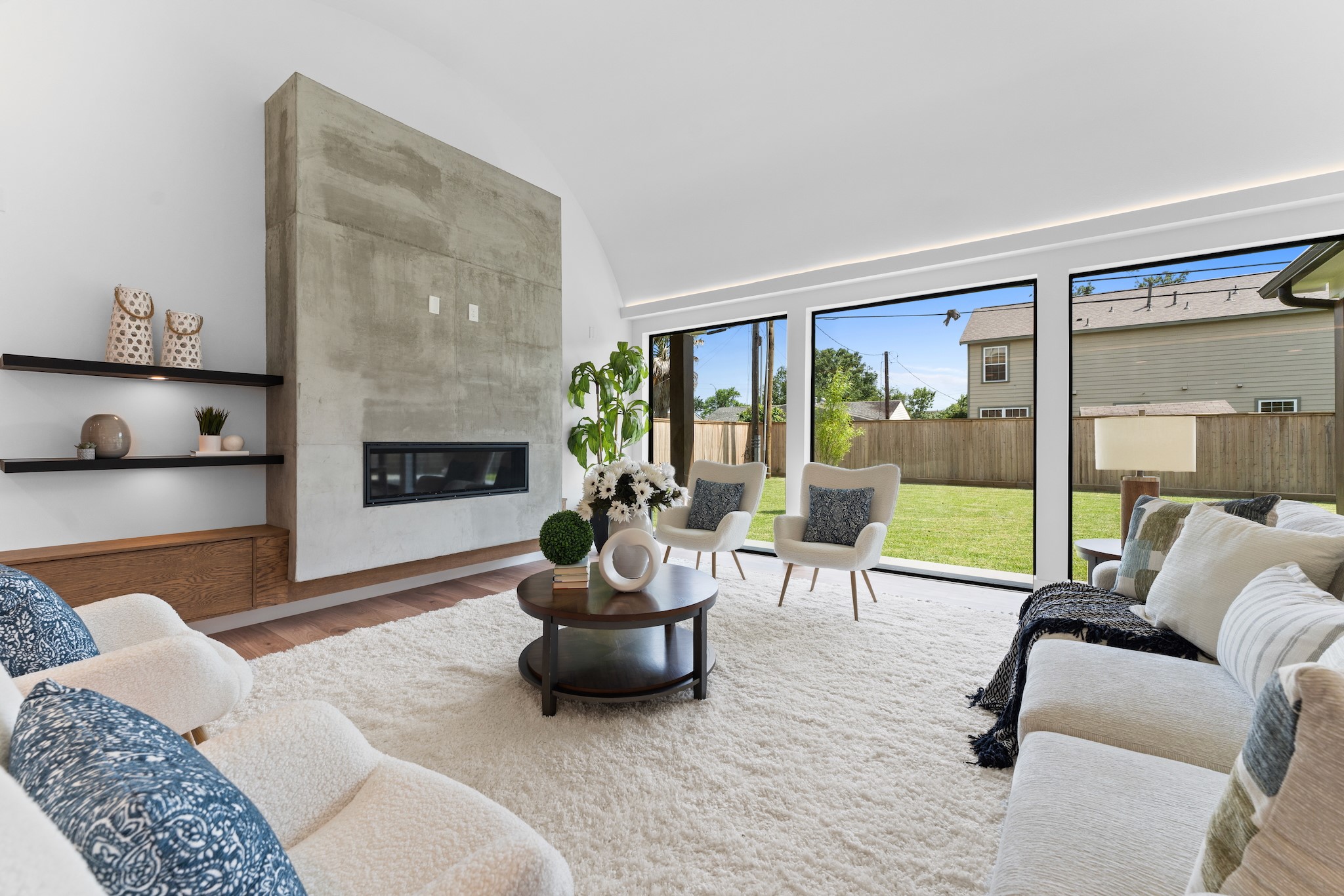6711 Housman Houston, TX 77055 - Photo 6 of 49 Walls of windows invite the outdoors in, while layered design textures ground the space with understated luxury.