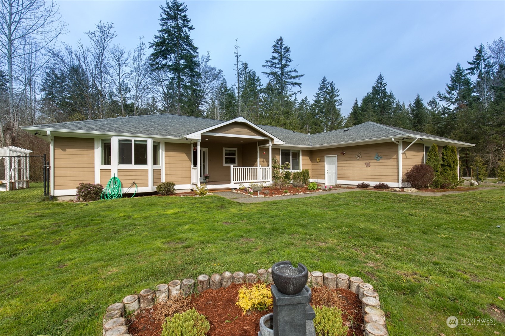 371 Autumn Road Sequim, WA 98382 - Photo 1 of 39 a front view of a house with a garden