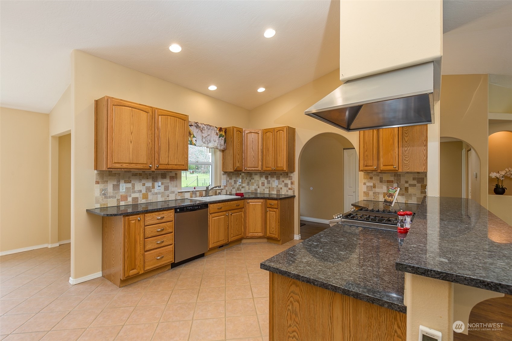 371 Autumn Road Sequim, WA 98382 - Photo 11 of 39 a kitchen with granite countertop kitchen island stainless steel appliances a sink a counter top space and cabinets