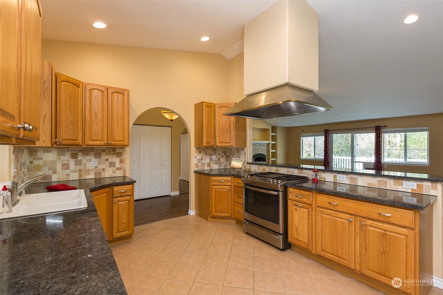 371 Autumn Road Sequim, WA 98382 - Photo 13 of 39 a kitchen with stainless steel appliances granite countertop a sink a stove and a refrigerator