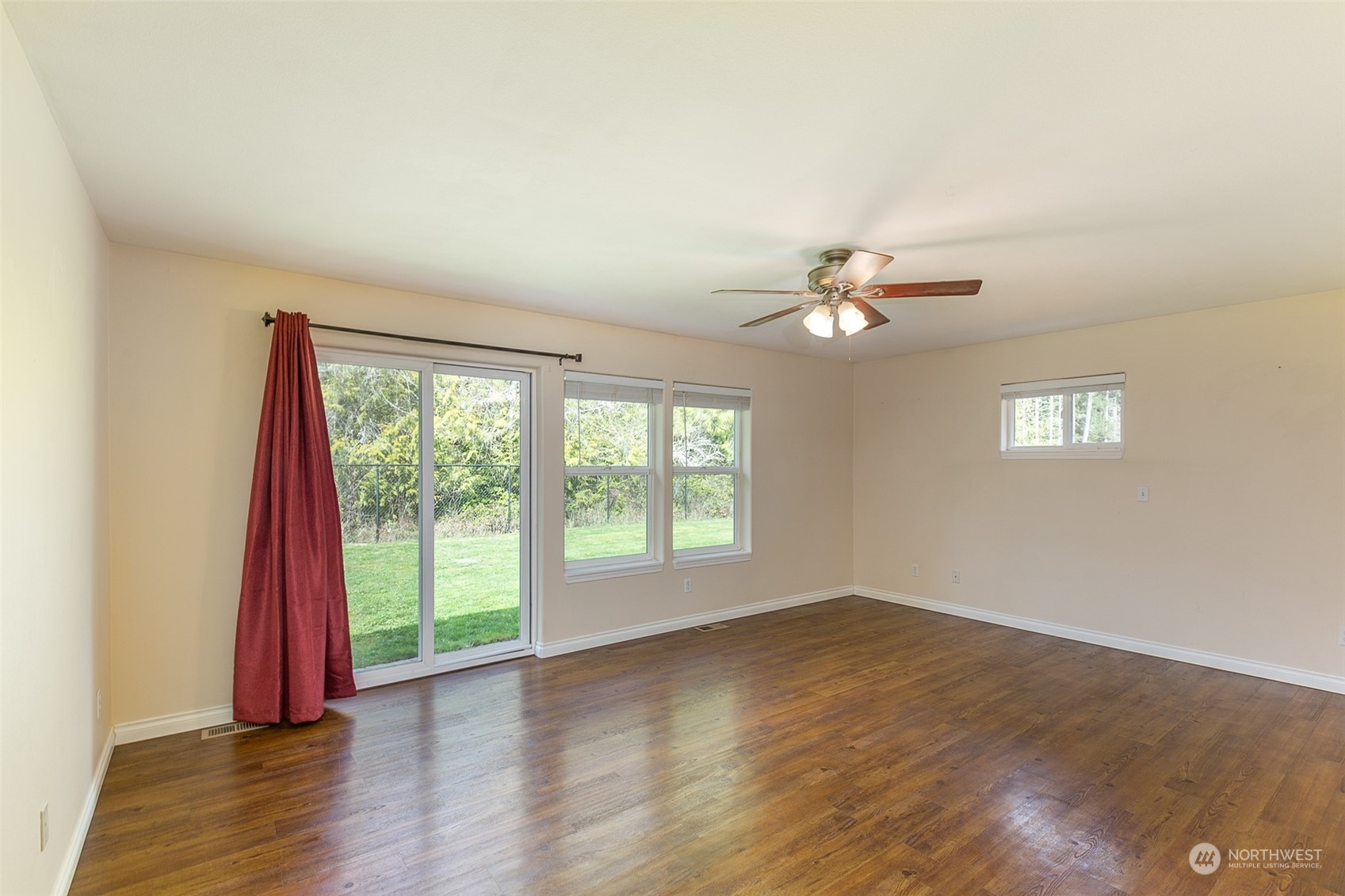 371 Autumn Road Sequim, WA 98382 - Photo 16 of 39 a view of an empty room with wooden floor and a window