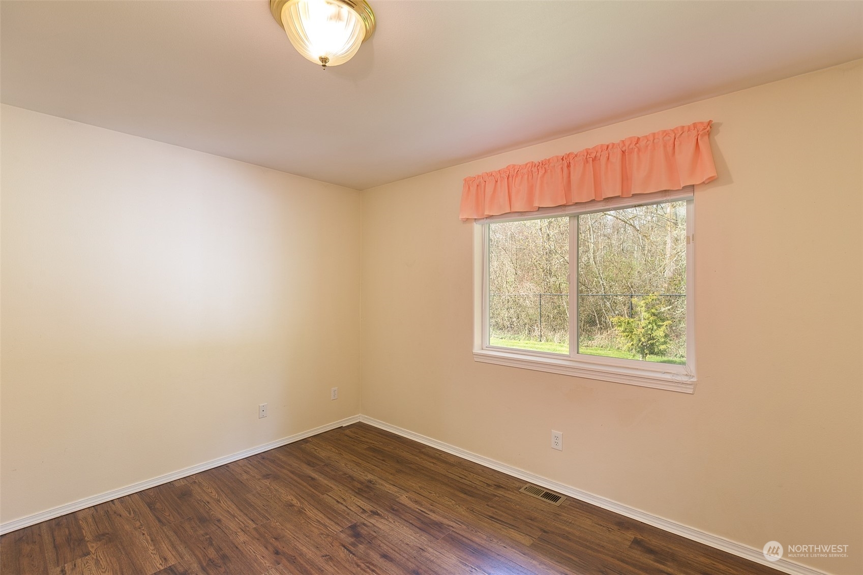 371 Autumn Road Sequim, WA 98382 - Photo 24 of 39 an empty room with wooden floor and windows