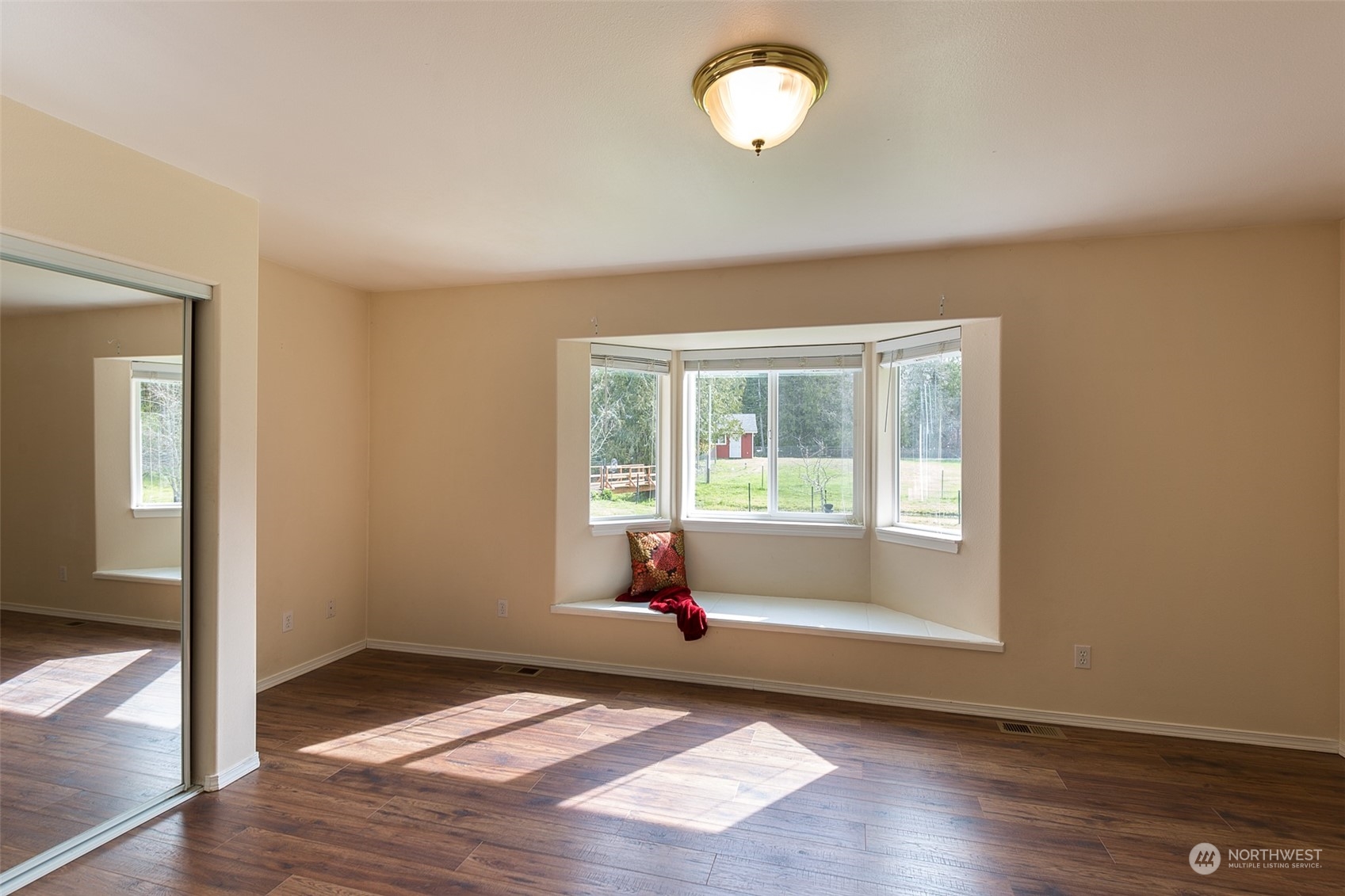371 Autumn Road Sequim, WA 98382 - Photo 25 of 39 an empty room with wooden floor and windows