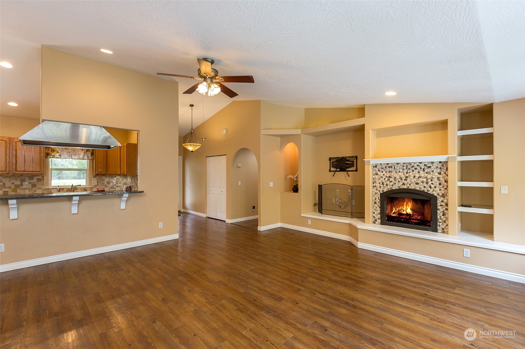 371 Autumn Road Sequim, WA 98382 - Photo 8 of 39 a view of an empty room with a fireplace and a window