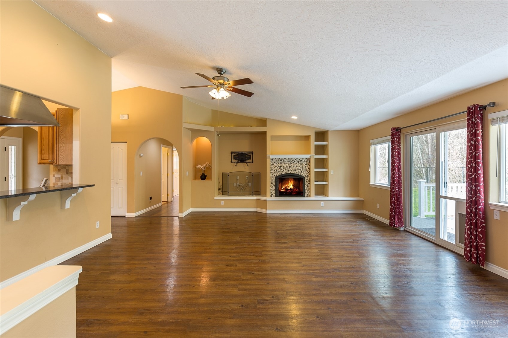 371 Autumn Road Sequim, WA 98382 - Photo 9 of 39 a view of empty room with a fireplace and wooden floor