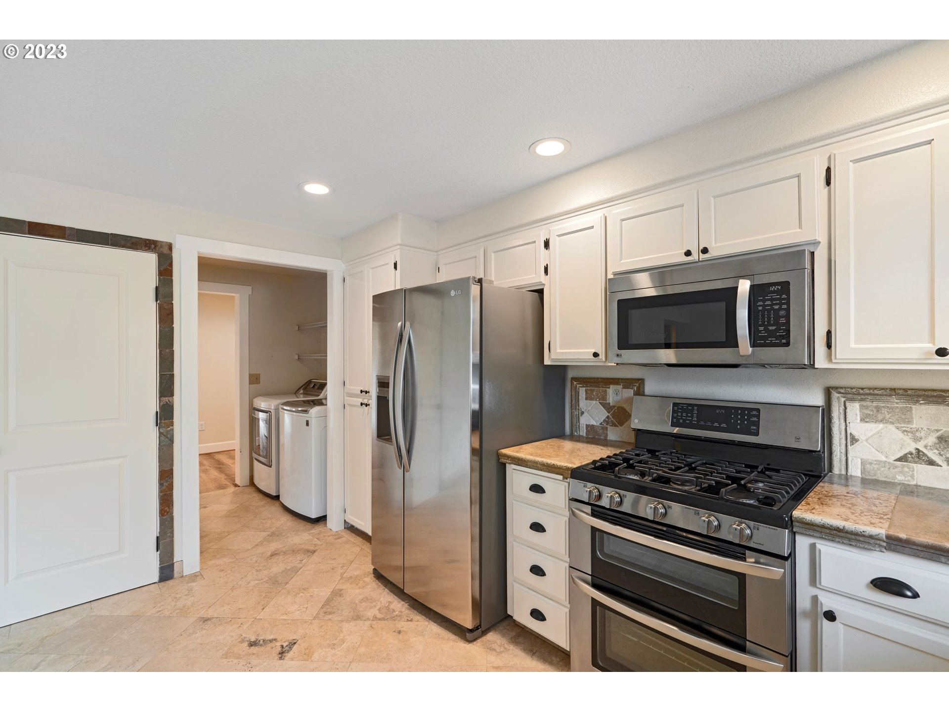 1635 Davis Road South Salem, OR 97306 - Photo 27 of 46 a kitchen with stainless steel appliances a stove a microwave a sink a refrigerator and cabinets