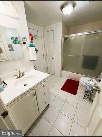 a spacious bathroom with a sink mirror and shower