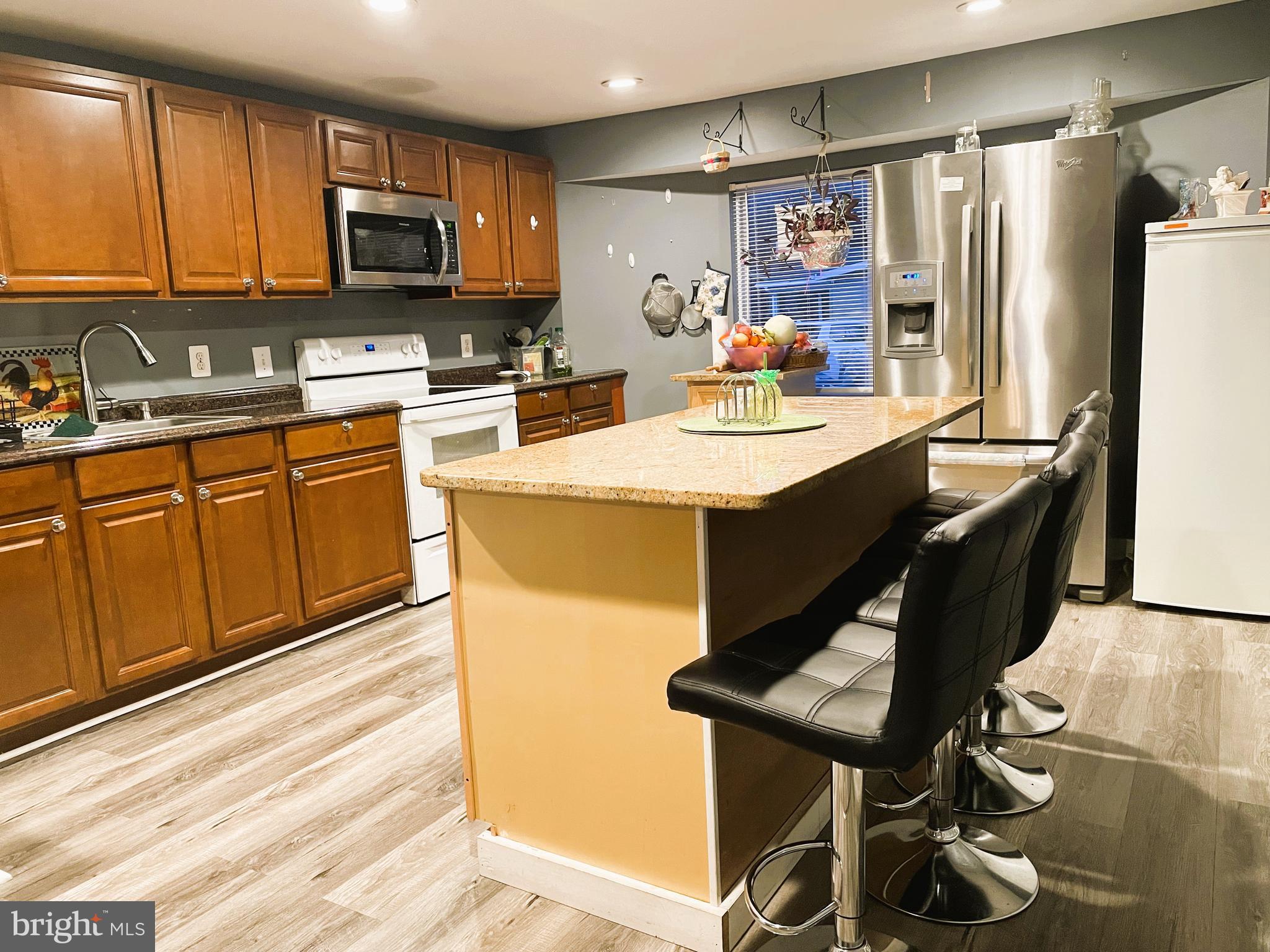 31 Courage Lane Stafford, VA 22554 - Photo 4 of 14 a kitchen with kitchen island a sink appliances and cabinets