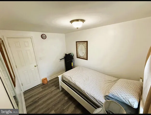 a bedroom with a bed and a night stand