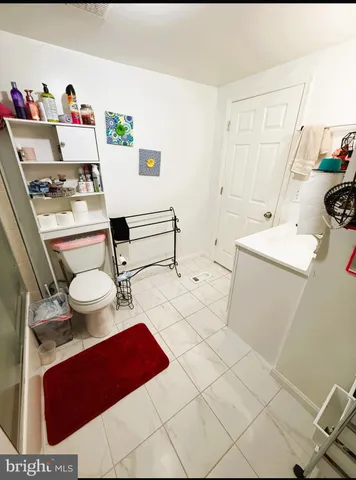 a bathroom with a sink toilet and a shower