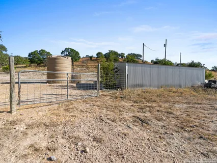 a view of dirt yard with a fountain