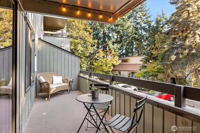 a view of a patio with table and chairs with wooden floor and fence