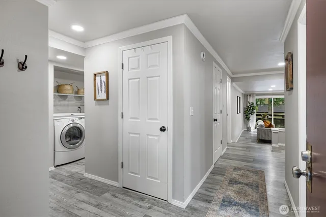 a view of a hallway to closet and wooden floor