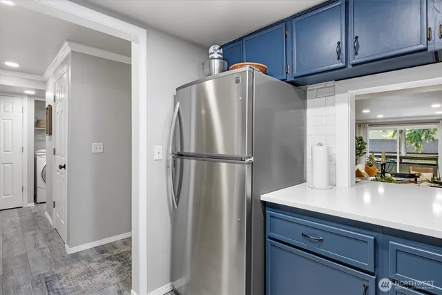 a kitchen with stainless steel appliances granite countertop a refrigerator and a sink