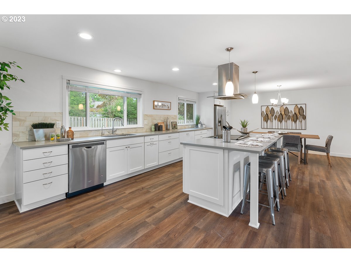 14720 Southwest Glenbrook Road Beaverton, OR 97007 - Photo 16 of 43 a kitchen with a sink cabinets and wooden floor