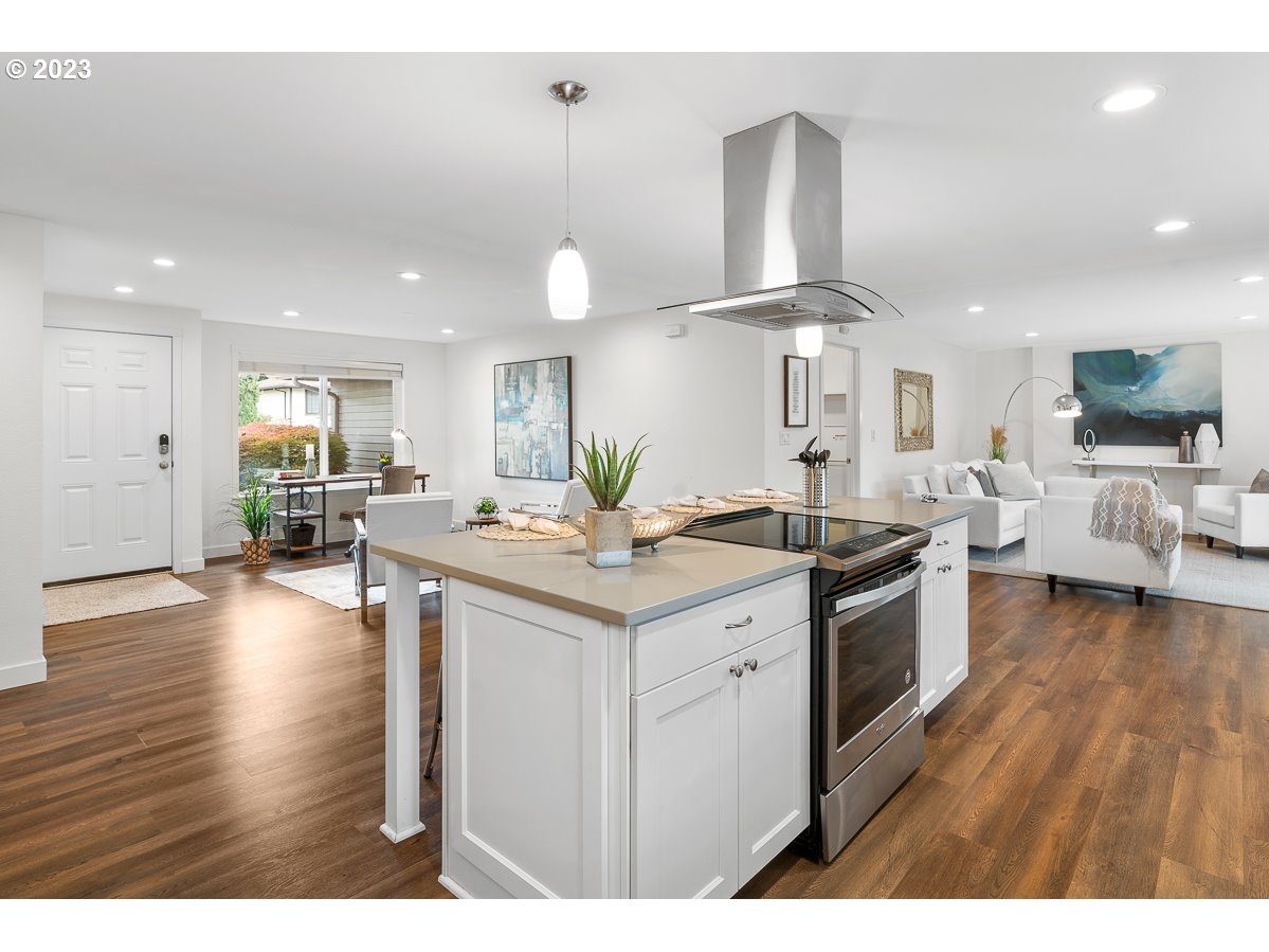 14720 Southwest Glenbrook Road Beaverton, OR 97007 - Photo 19 of 43 a kitchen with stainless steel appliances a stove top oven a sink a counter space and living room view