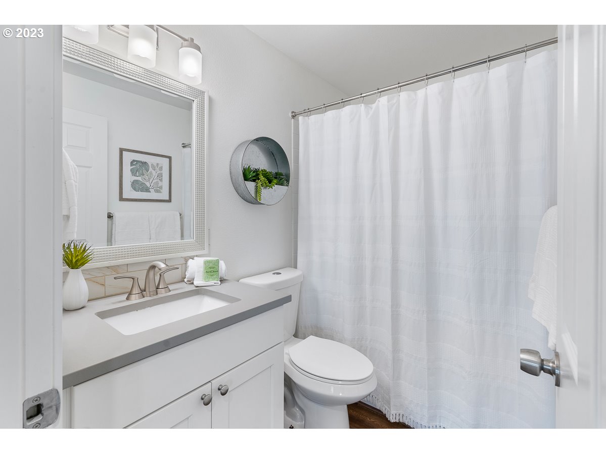 14720 Southwest Glenbrook Road Beaverton, OR 97007 - Photo 21 of 43 a bathroom with a sink mirror vanity and toilet