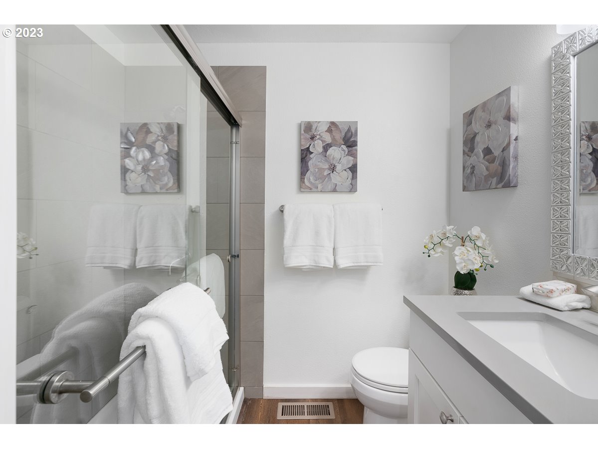 14720 Southwest Glenbrook Road Beaverton, OR 97007 - Photo 29 of 43 a bathroom with a toilet a sink and a mirror