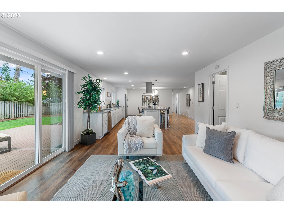 14720 Southwest Glenbrook Road Beaverton, OR 97007 - Photo 7 of 43 a living room with furniture and a floor to ceiling window