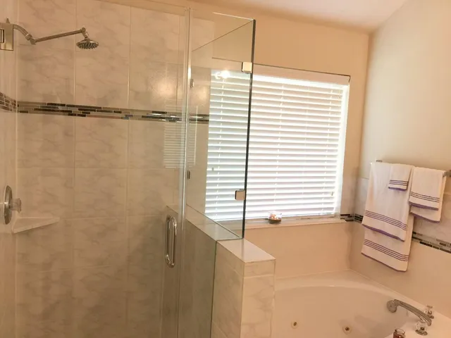 a bathroom with a shower and a window