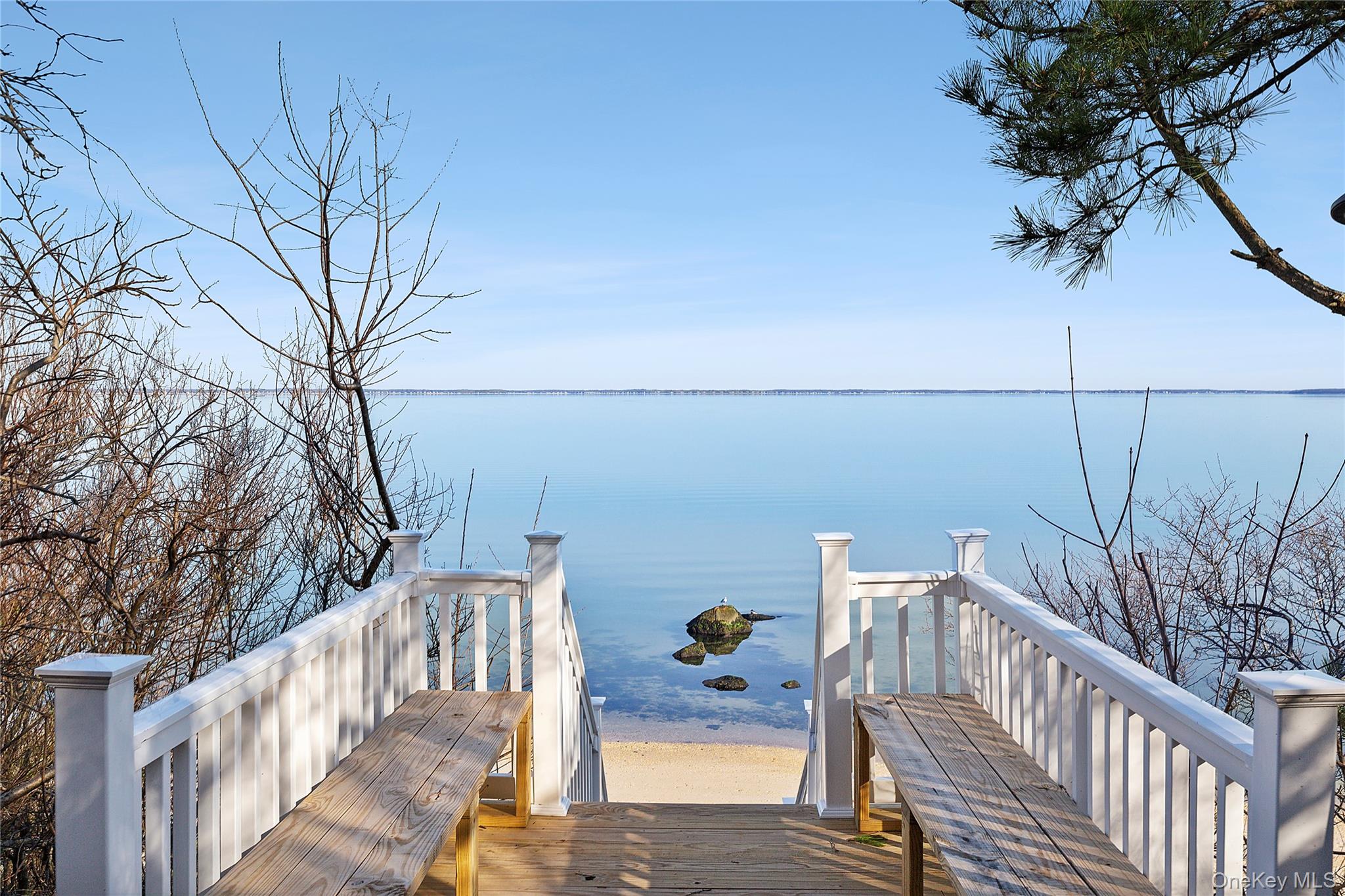 67 North Road, Unit A Hampton Bays, NY 11946 - Photo 15 of 17 a view of deck with seating and trees
