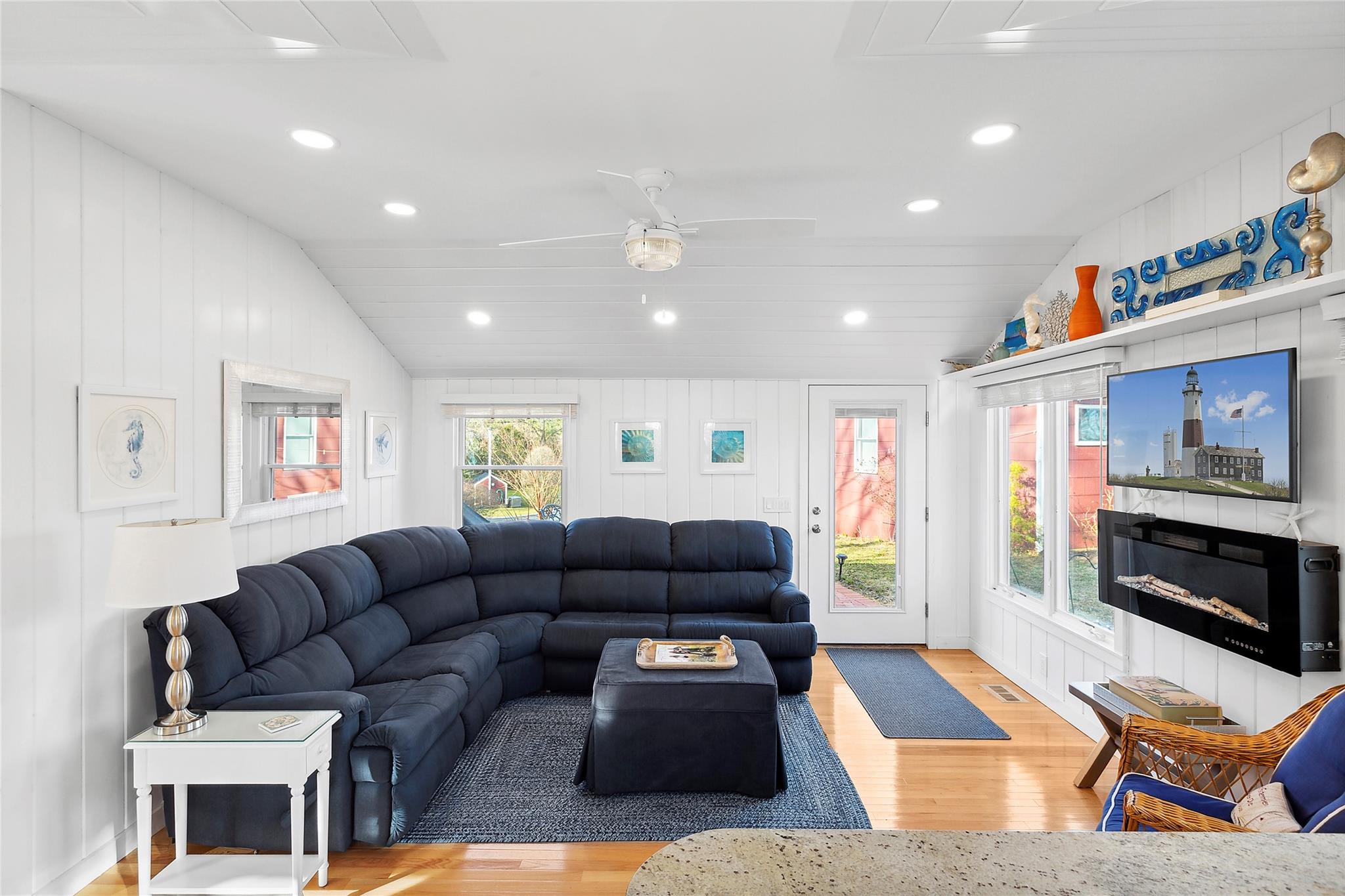 67 North Road, Unit A Hampton Bays, NY 11946 - Photo 5 of 17 Living room featuring wood finished floors, recessed lighting, a fireplace, lofted ceiling, and a ceiling fan
