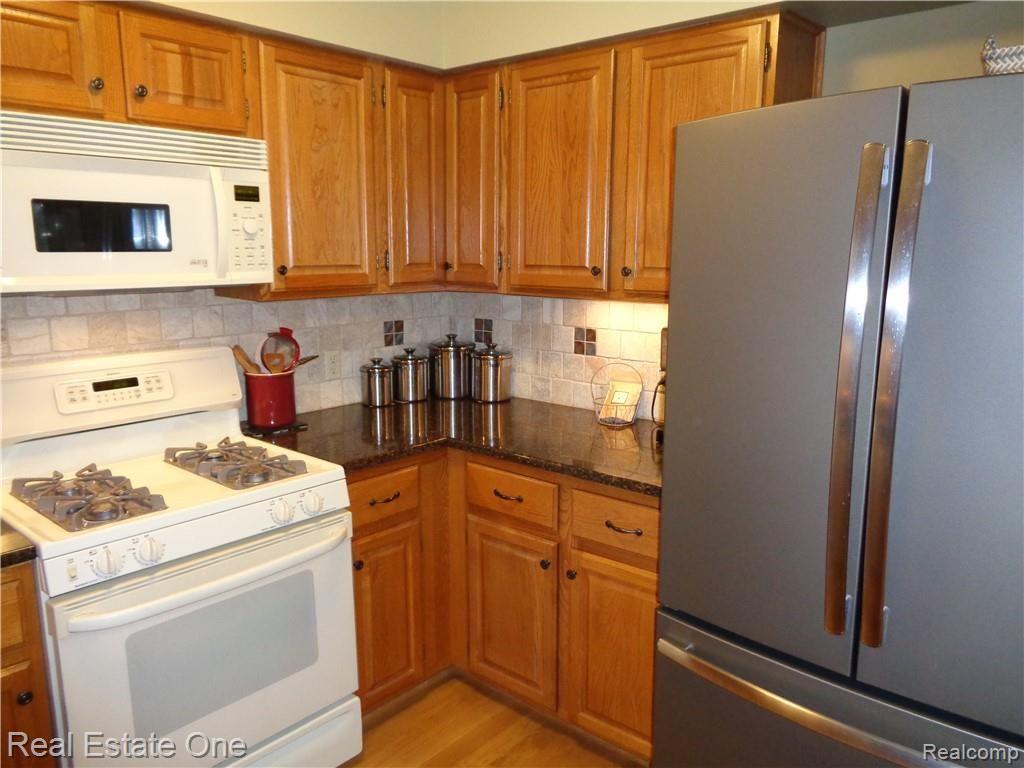 9590 Ridge Top Trail Clarkston, MI 48348 - Photo 10 of 80 Upgraded Convection Microwave and 2013 GE 26.3 cu ft Slate French Door style with freezer at bottom Frig ($1700)