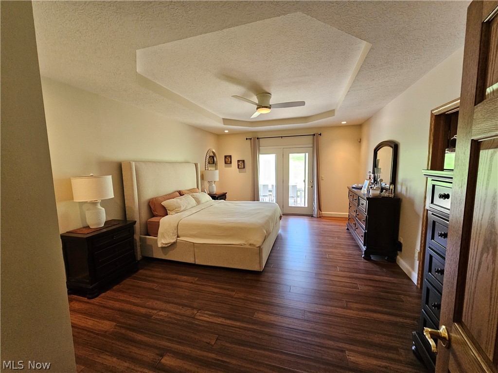 2363 Tabor Ridge Road Northeast New Philadelphia, OH 44663 - Photo 26 of 42 Spacious room featuring wood-finish flooring and a tray ceiling with a ceiling fan