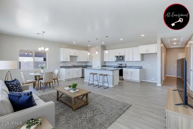 a living room with furniture and kitchen view