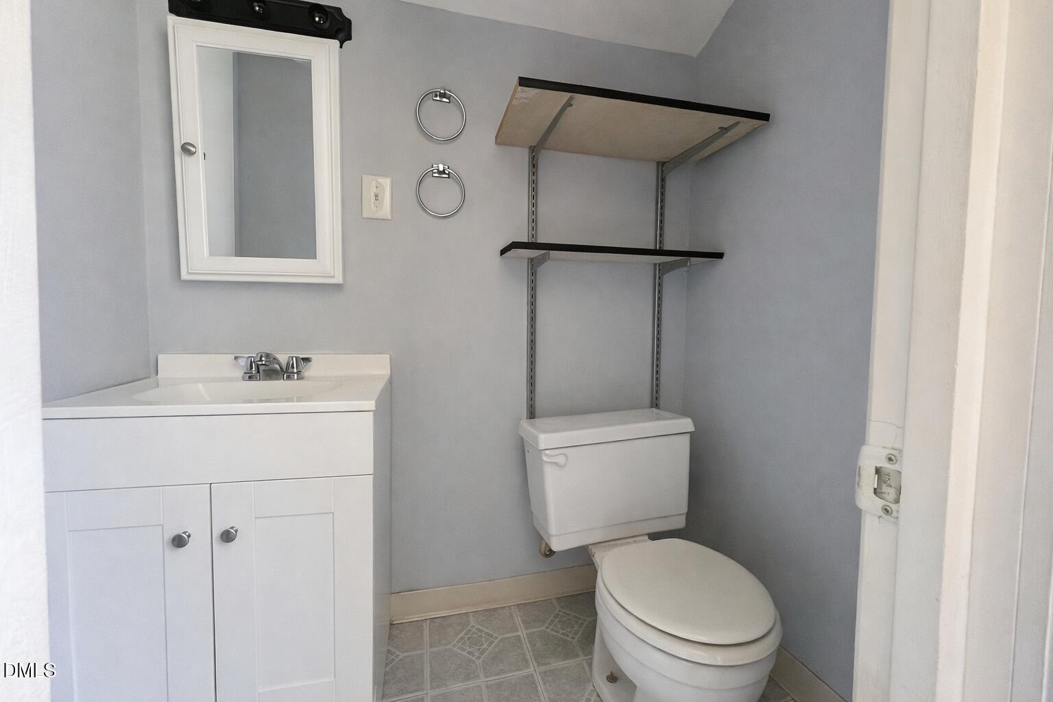151 Watson Road Norlina, NC 27563 - Photo 12 of 16 a bathroom with a toilet sink vanity and shower