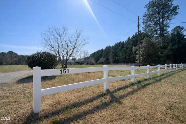 a view of a yard with wooden fence