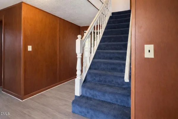 a view of entryway and gallery with wooden floor