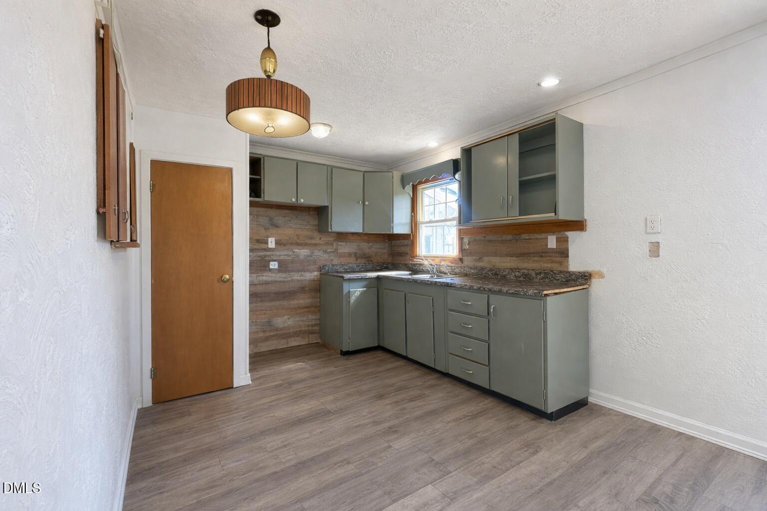 151 Watson Road Norlina, NC 27563 - Photo 6 of 16 a kitchen with granite countertop a sink cabinets and stainless steel appliances