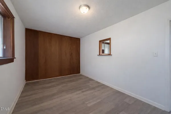 an empty room with windows and closet