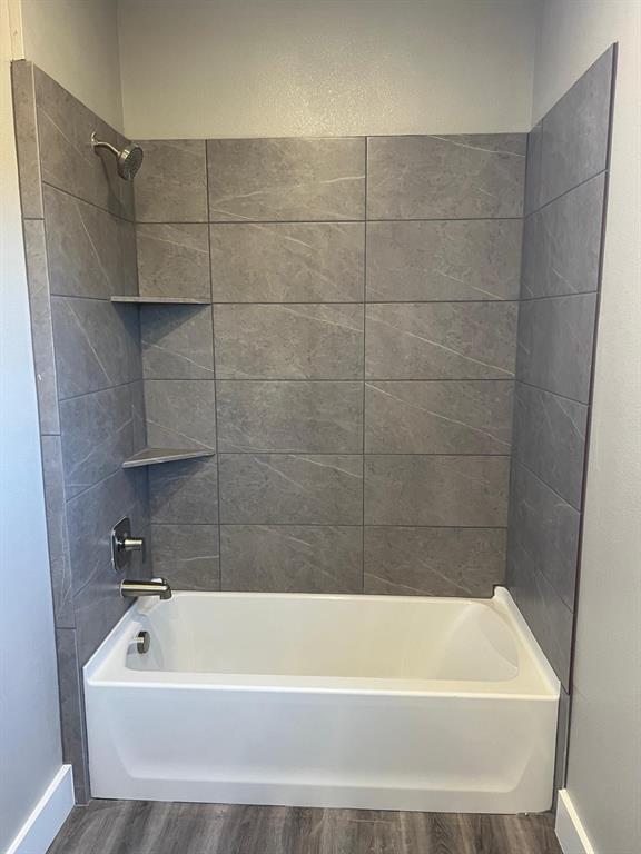 443 Richlands Way Fate, TX 75087 - Photo 13 of 20 Full bath featuring shower combination and wood finished floors