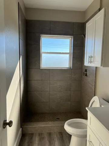 a bathroom with a toilet and a shower