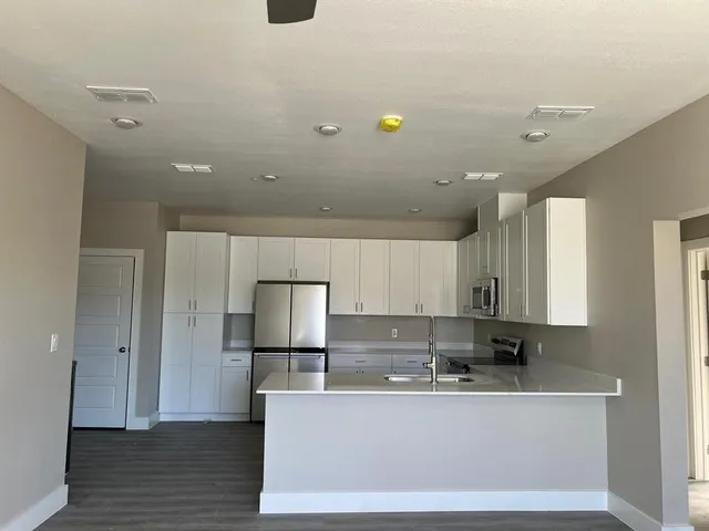 a view of a kitchen with white cabinets