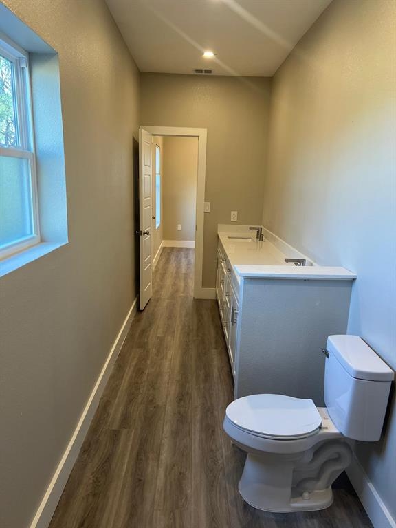 443 Richlands Way Fate, TX 75087 - Photo 5 of 20 Bathroom with dark wood-style floors and vanity