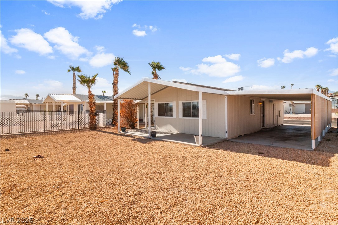 1671 Granada Street Laughlin, NV 89029 - Photo 37 of 63 Back of property with fence and an attached carport