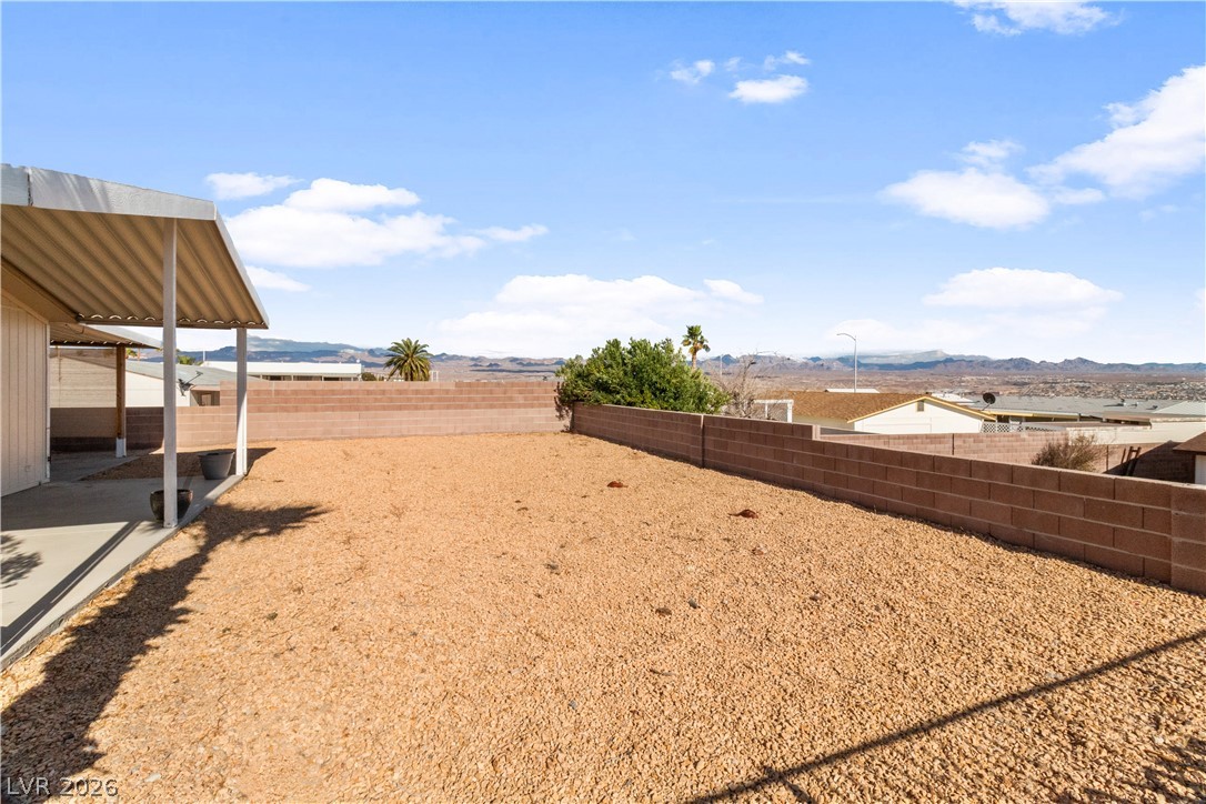1671 Granada Street Laughlin, NV 89029 - Photo 40 of 63 View of yard featuring a fenced backyard and a mountain view