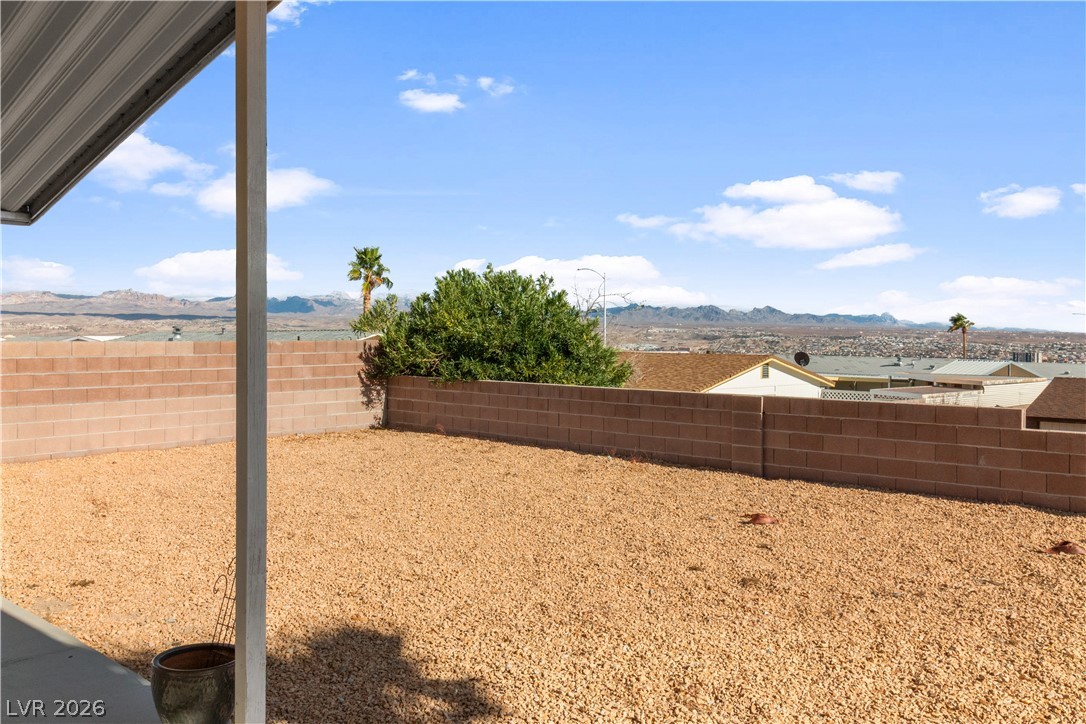 1671 Granada Street Laughlin, NV 89029 - Photo 43 of 63 View of yard with a fenced backyard and a mountain view