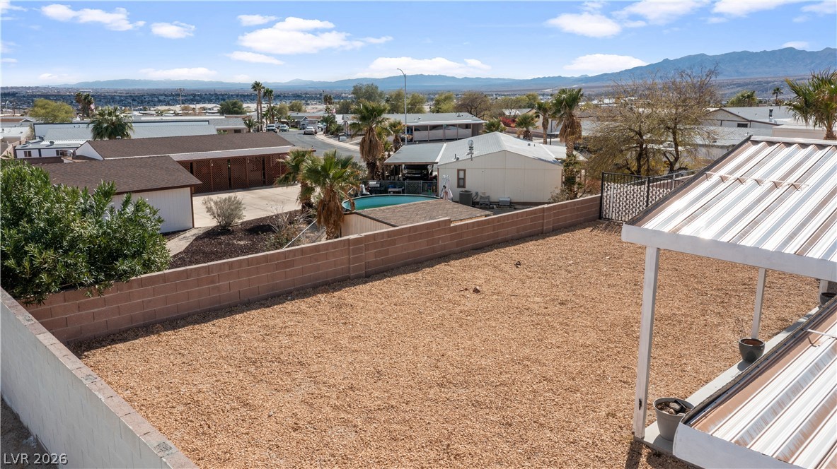 1671 Granada Street Laughlin, NV 89029 - Photo 51 of 63 View of yard with a residential view, a fenced backyard, and a mountain view