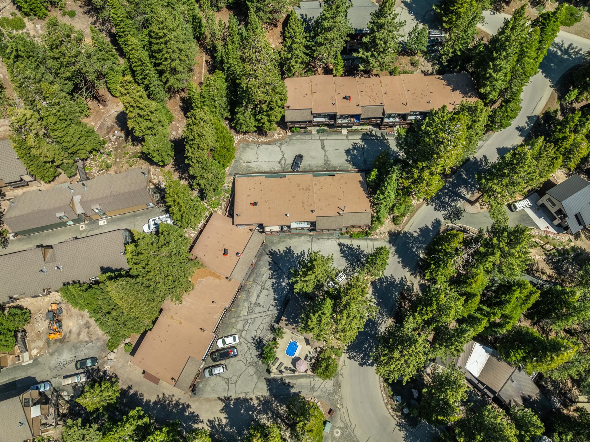 50 Hidden Valley Road, Unit 17 Mammoth Lakes, CA 93546 - Photo 38 of 40 Aerial perspective showcasing multiple residential structures with brown roofing surrounded by mature evergreen trees