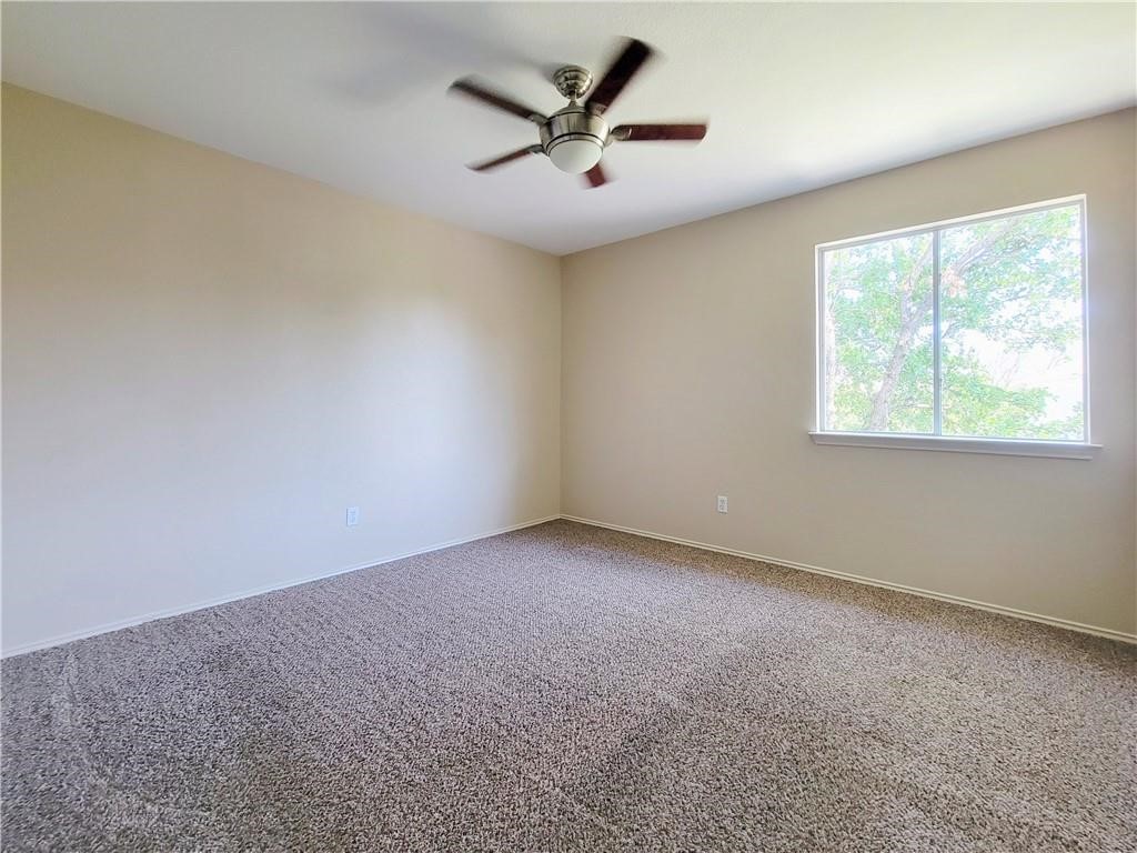 610 Cenizo Path Cedar Park, TX 78613 - Photo 14 of 18 an empty room with a window and a ceiling fan