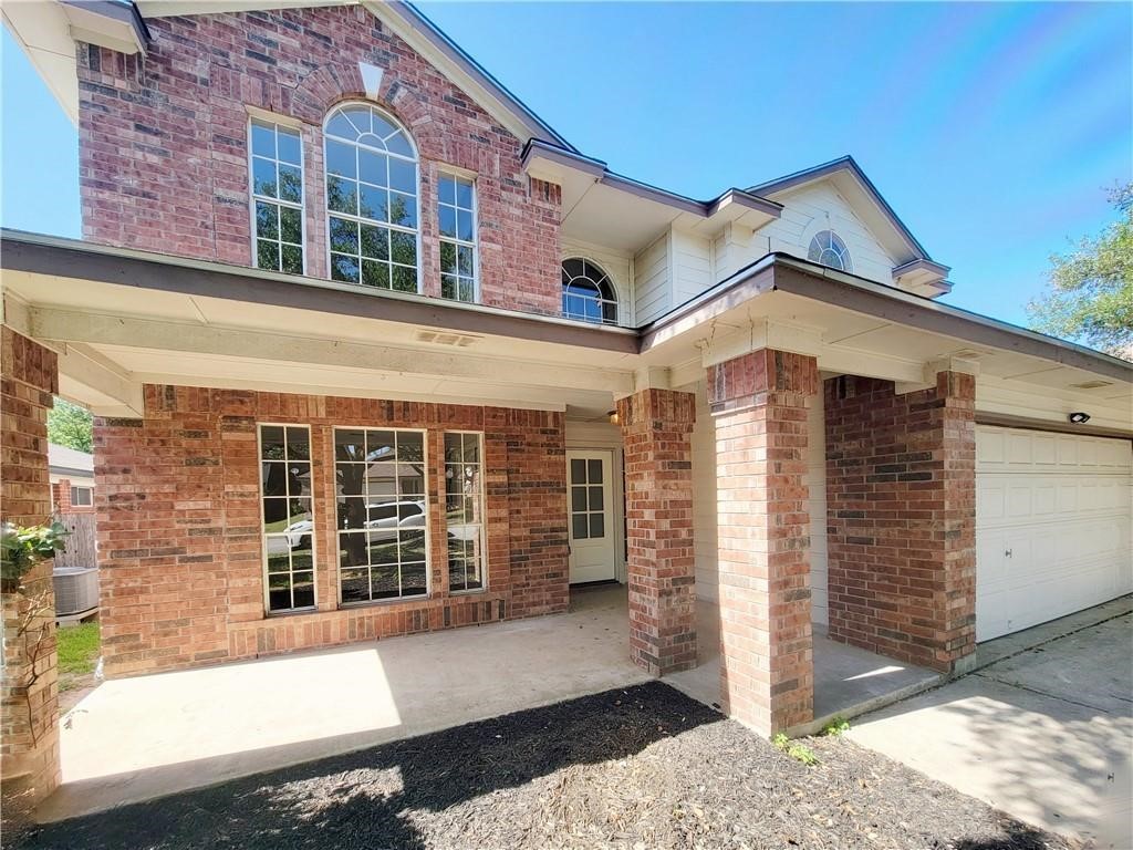 610 Cenizo Path Cedar Park, TX 78613 - Photo 2 of 18 a view of a brick house with large windows