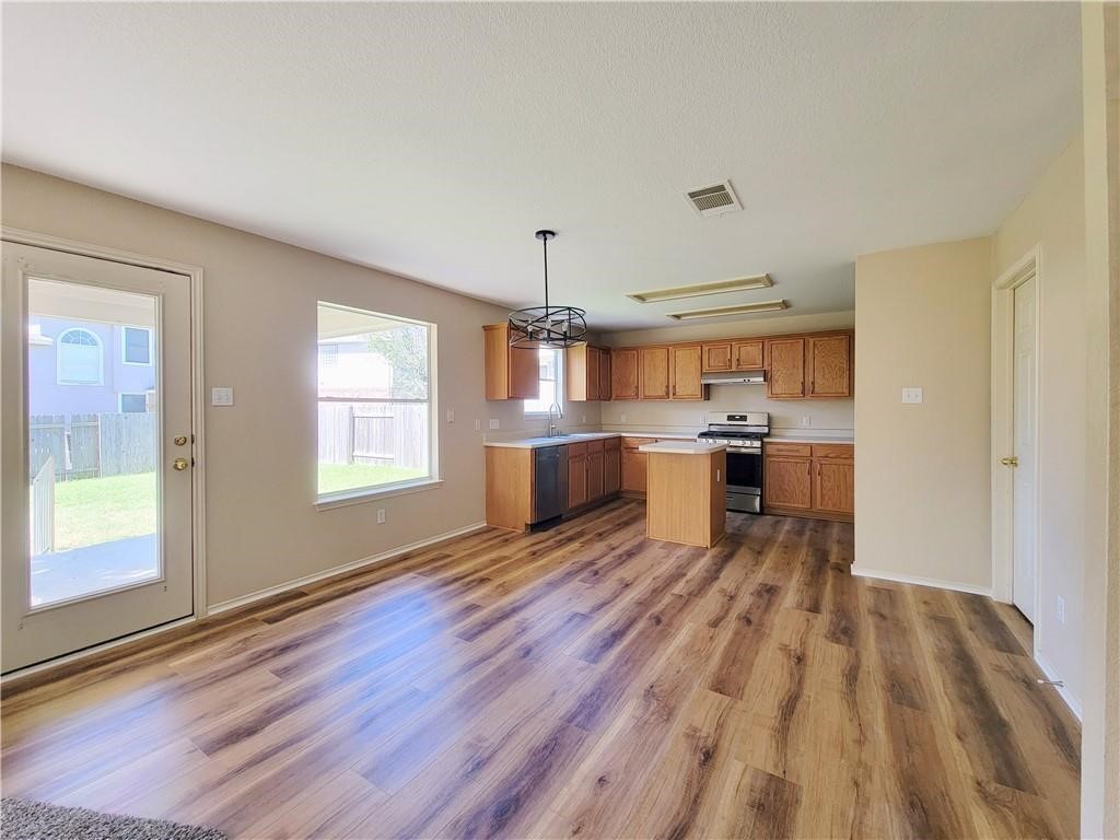 610 Cenizo Path Cedar Park, TX 78613 - Photo 5 of 18 a kitchen with stainless steel appliances granite countertop a sink cabinets and wooden floor