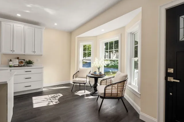 a living room with furniture wooden floor and a window